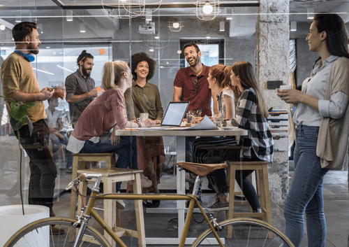 Fahrrad Leasing durch Arbeitgeber: Junge Kollegen Im Meeting Mit Fahrrad