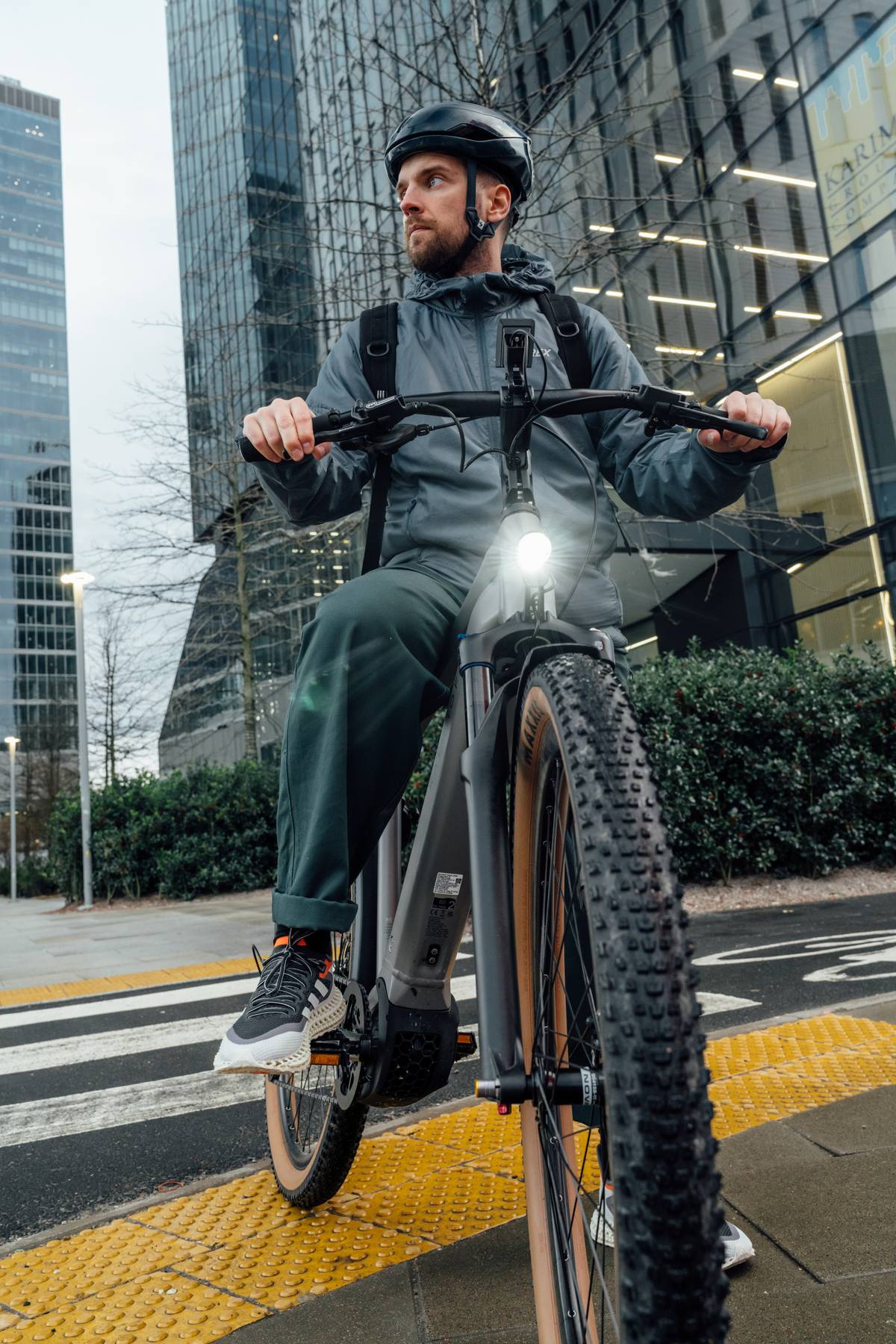 man on bike in front of building